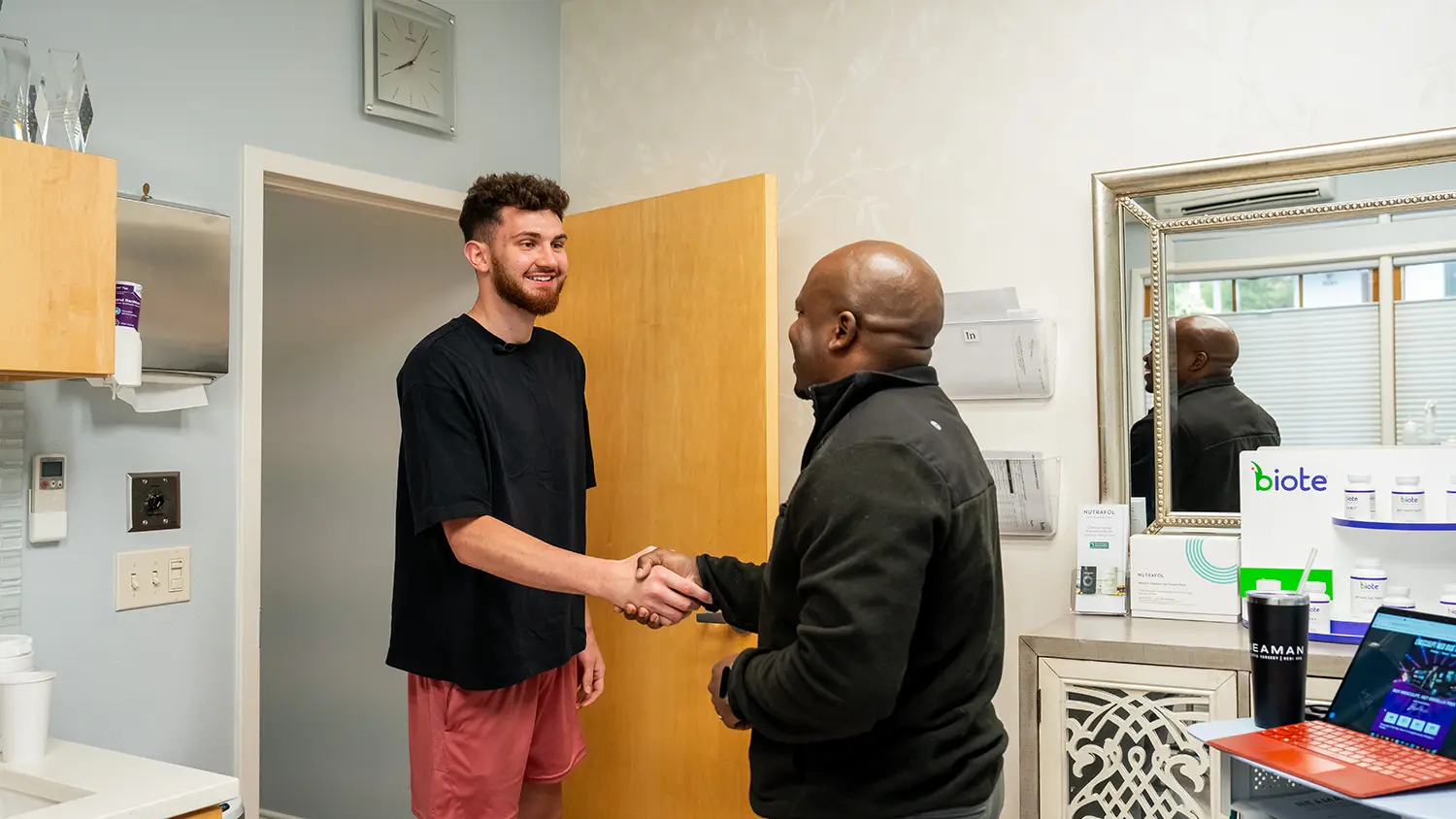 handshake between an athlete and medical care provider